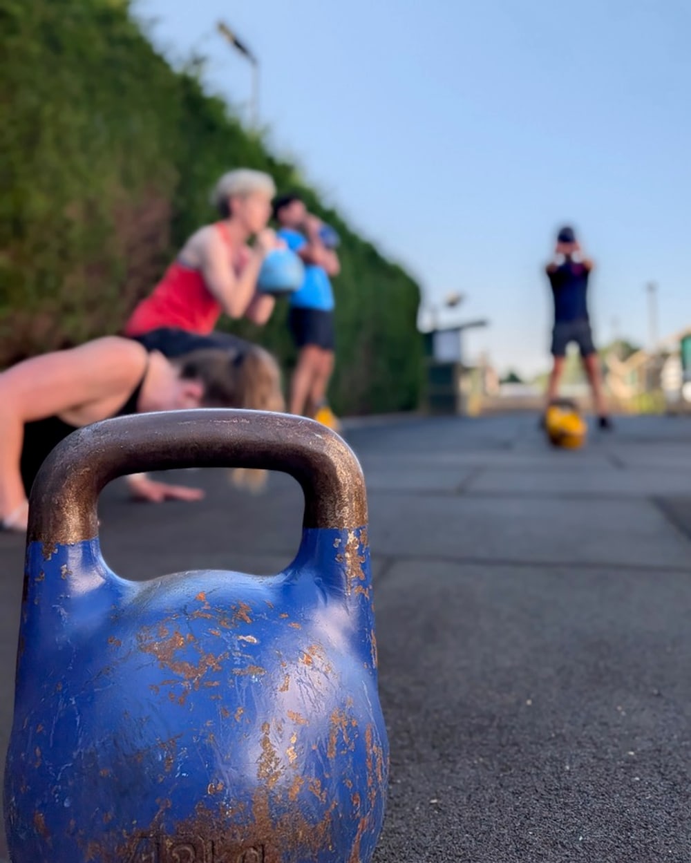 A small group kettlebell session training outdoors
